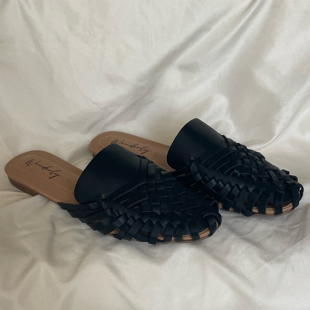Wonderly brand mules feature a black woven design and a slip-on style